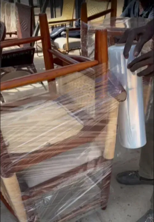Dining chairs being stretch-wrapped for the move